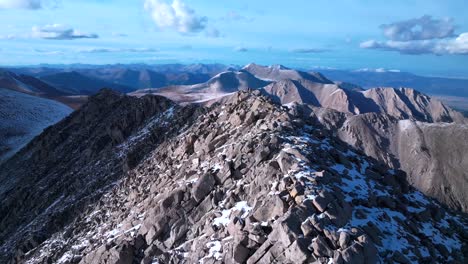 top of snow covered mt mount shavano taeguache peak aerial drone colorado collegiate peaks golden hour rocky mountains huron peak mt elbert sawatch range above treeline fall autumn forward motion
