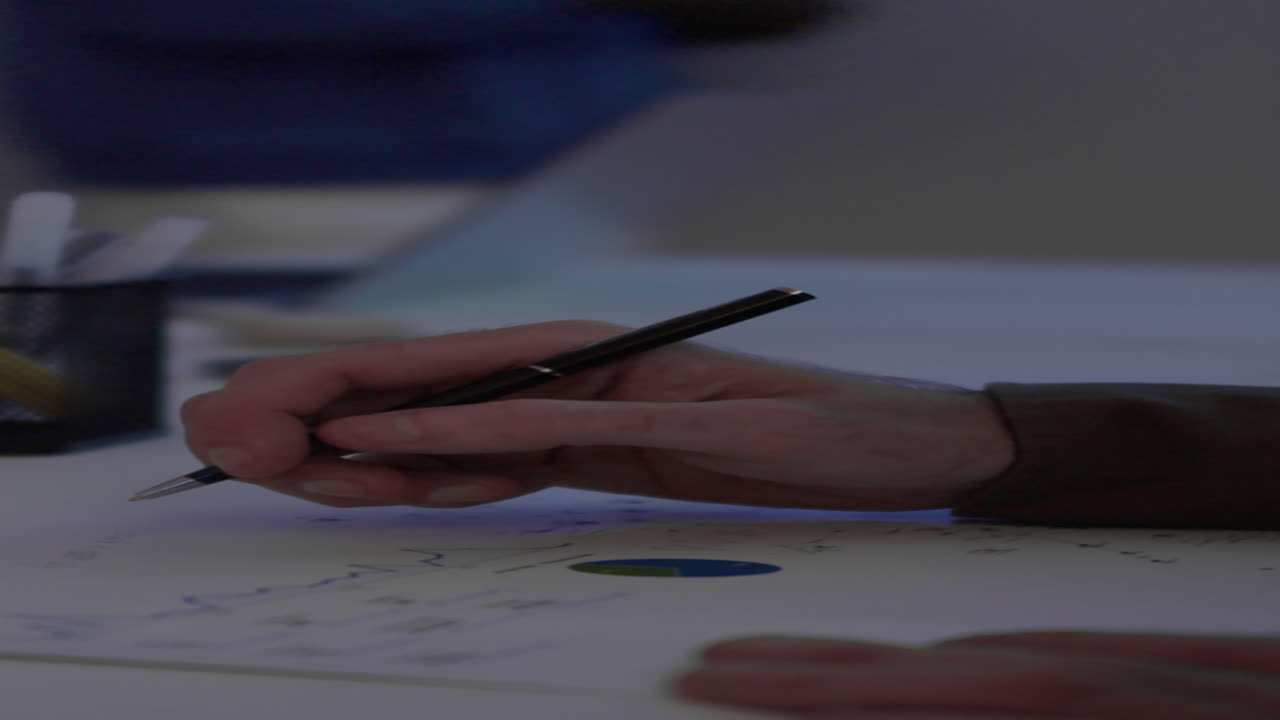 Hands of Analyst Checking Stock Market Document