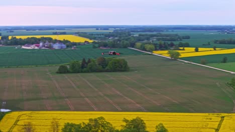 aerial drone slowly circling drone over varied farmland landscape of trees, fields, and hills