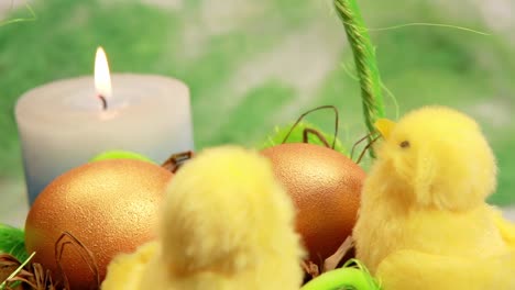 easter basket with eggs, chicks, and candle