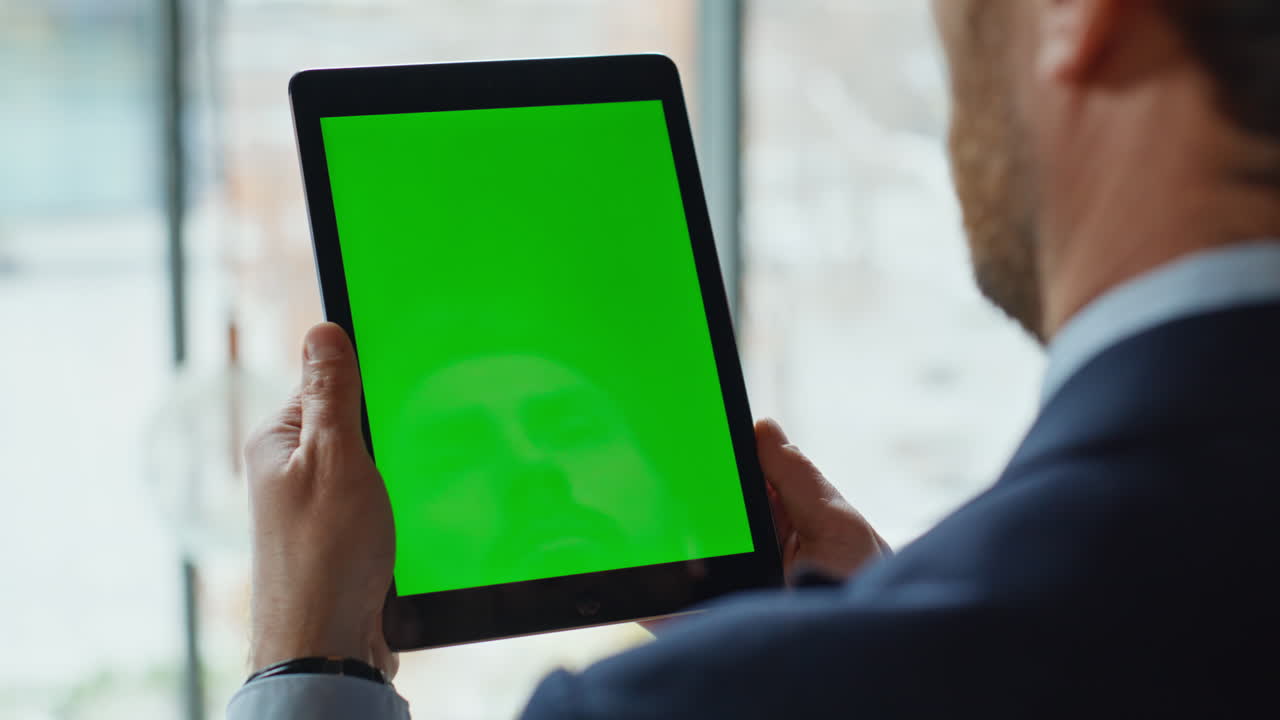 Ceo looking chromakey tablet reading financial report in office closeup