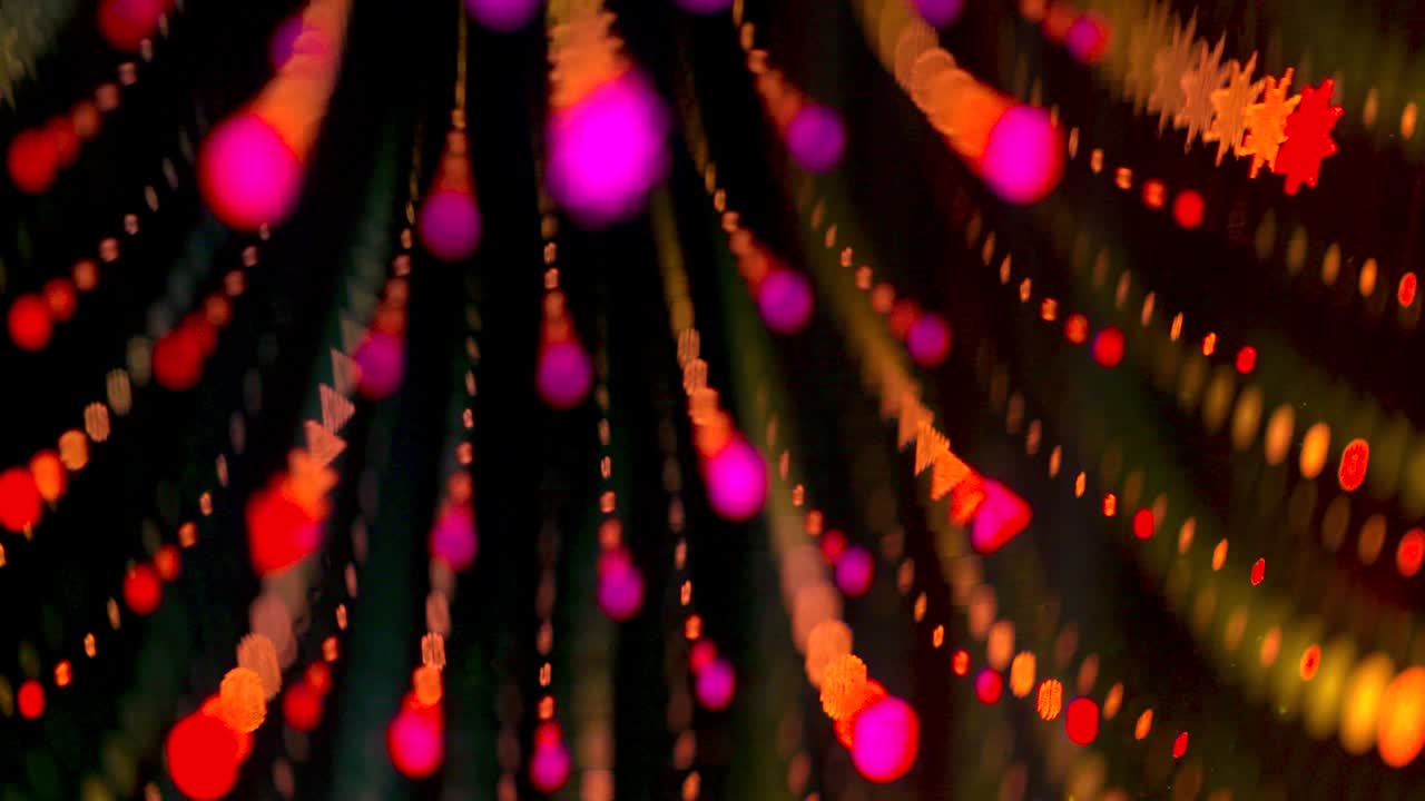 Infinity bulb colorful mirror effect, slow spinning bokeh flower texture movement against black background