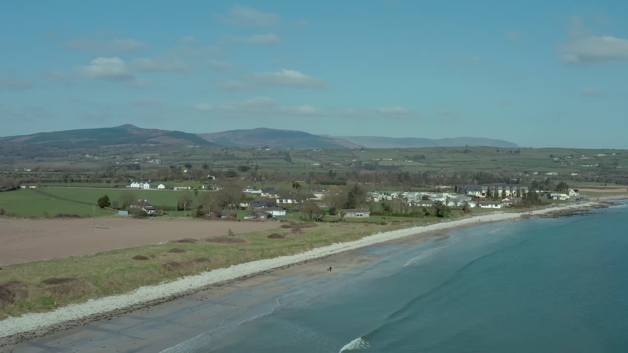 Aerial dolly in over low tide ocean at beach seaside at day in summer