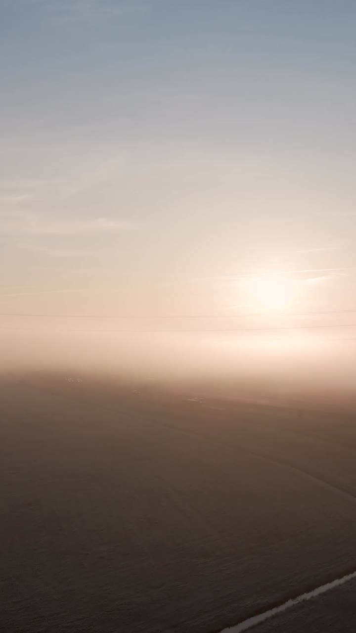 Sunrise through Foggy Landscape
