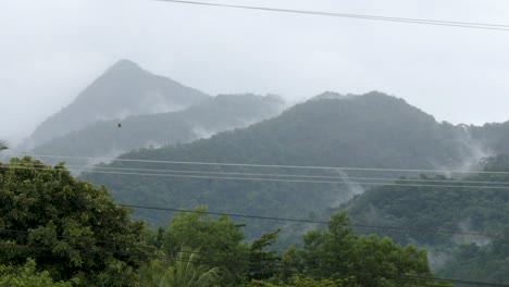Hazy-wide-angle-view-of-mountain-range-on-tropical-island