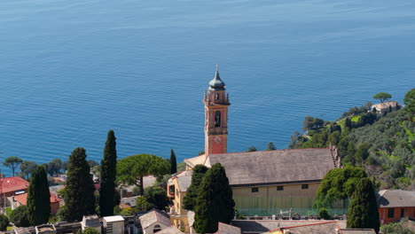 close-up of a church and bell tower on a hillside in the italian riviera