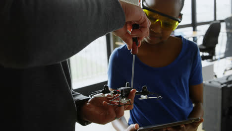 Father and daughter repairing a drone 4k