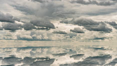 futuristic background consisting of time lapse clip of white fluffy clouds over blue sky and their reflection, video loop