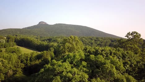 aerial of pilot mountain as camera pushes toward summit in 4k