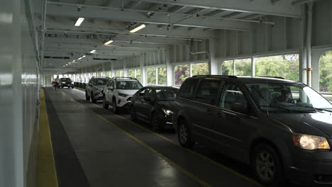 timelapse capturing the process of cars boarding a washington state ferry, as vehicles line up one after another on the vehicle deck. the scene showcases efficient ferry loading and maritime transport
