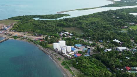 coastal fuel storage facility in lush, tropical island facing turquoise ocean waters at catanduanes, philippines