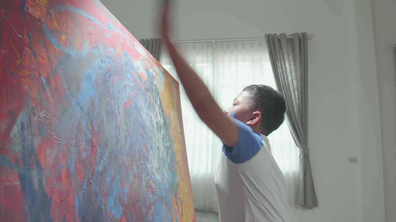 Child interacting with large abstract painting