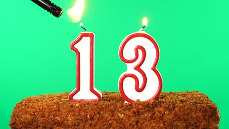 cake with the number 13 lighted candle. chroma key. green screen. isolated