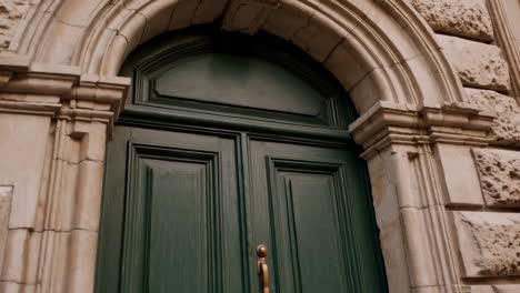 historic green wooden door with stone archway