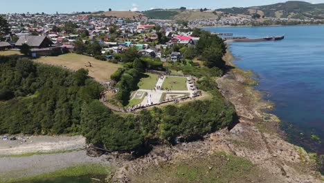 an aerial perspective of fuerte san antonio in ancud, chiloé island, showcasing history. orbit motion shot