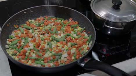 pan fry meal of delicious asparagus, pepper, corn and carrot. vegetarian meal