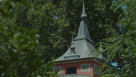 ornate architectural turret amidst lush green trees