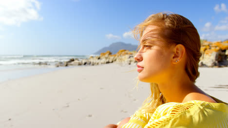 Close-up-of-young-Caucasian-woman-sitting-on-the-sand-4k