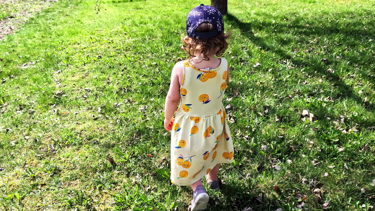 Girl smiling and looking back in summer dress during follow shot in slow motion