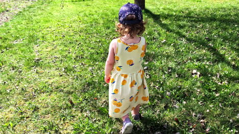 girl smiling and looking back in summer dress during follow shot in slow motion