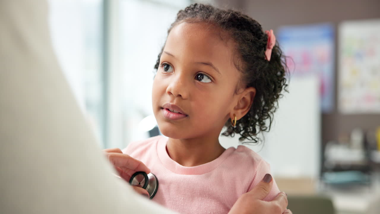 Doctor examining a young girl with a stethoscope