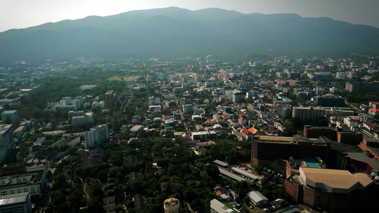 Aerial Scenic Drone Footage of the City of Chiang Mai, Thailand Covered in Smog on a Sunny Day during the Smokey Burning Season