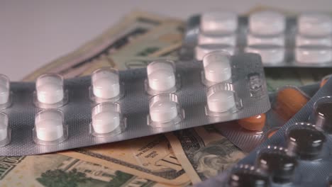 Close-Shot-of-Pills-and-US-Dollar-Bills