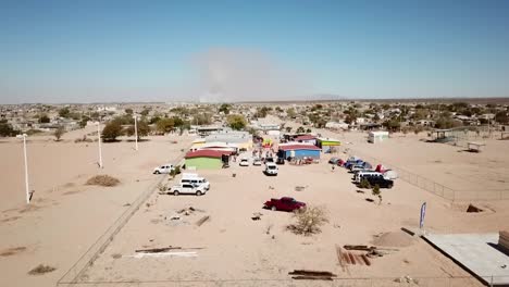 Aerial-view-of-a-Mexican-schoolhouse-in-the-summer-heat-with-kids-playing-outside