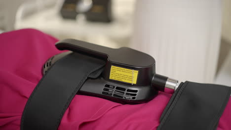 close-up of a medical therapy device strapped to a body