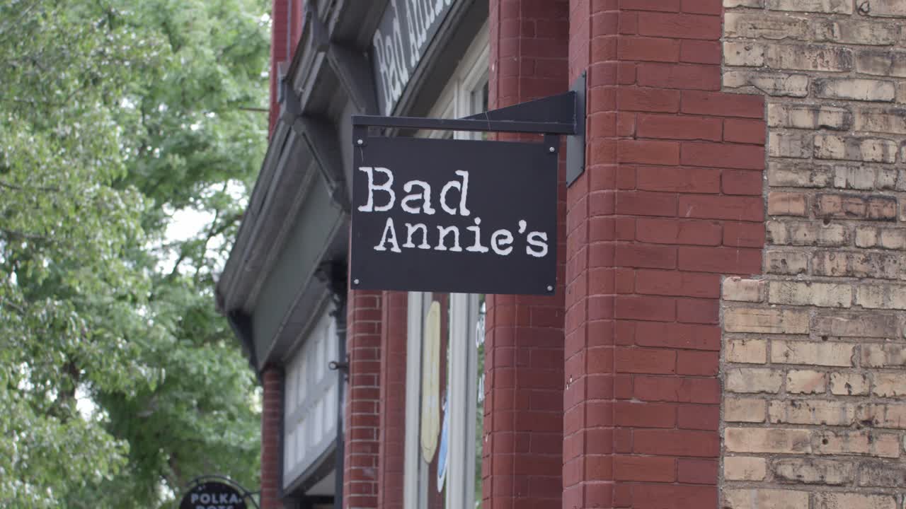 Bad Annie's store sign in Lansing, M Michigan Old Town district with stable video establishing shot