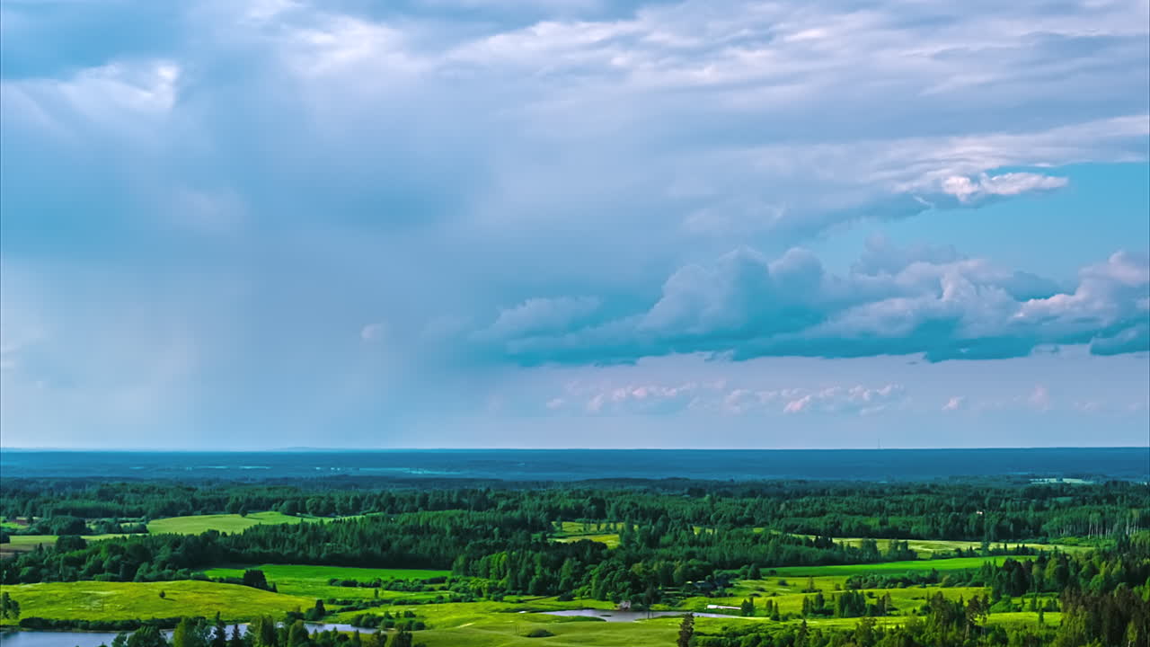 Drone hyperlapse of sunlight breaking through clouds over scenic countryside