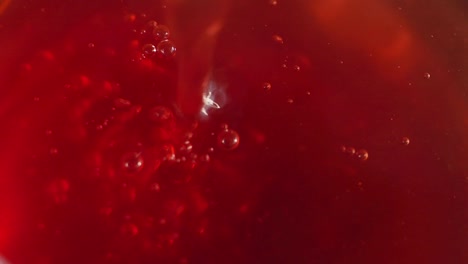 close-up of red liquid with bubbles