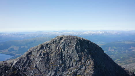 aerial orbital shot of a rocky peak