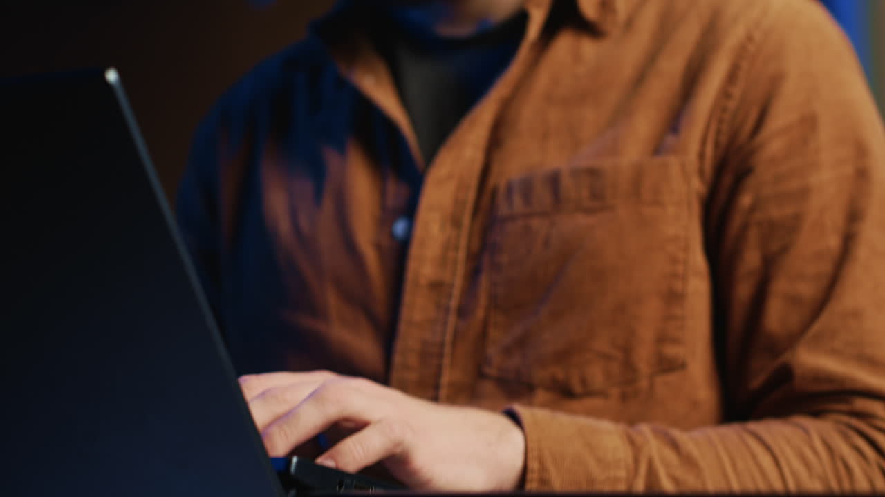 Programmer concentrating on writing binary code scripts on laptop, close up