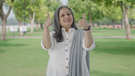 Happy-Indian-mother-showing-thumbs-up-in-park