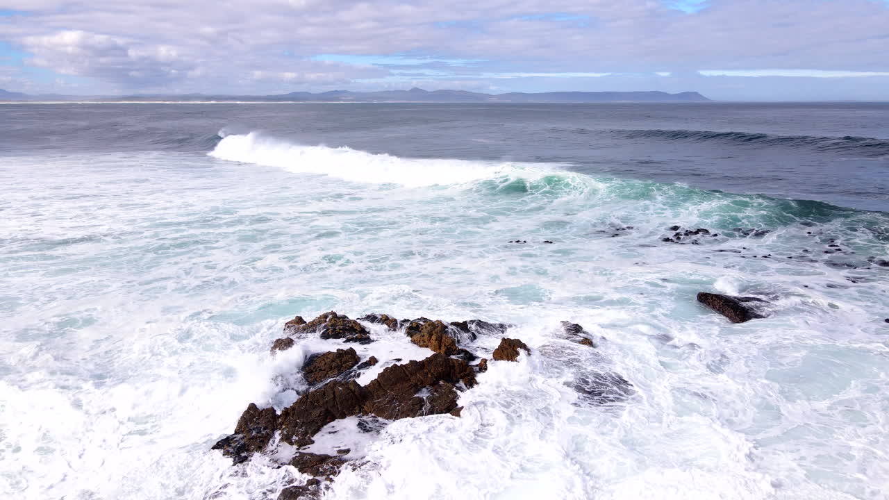 Drone slow motion, Atlantic sea waves frothing seawater surging onto shoreline