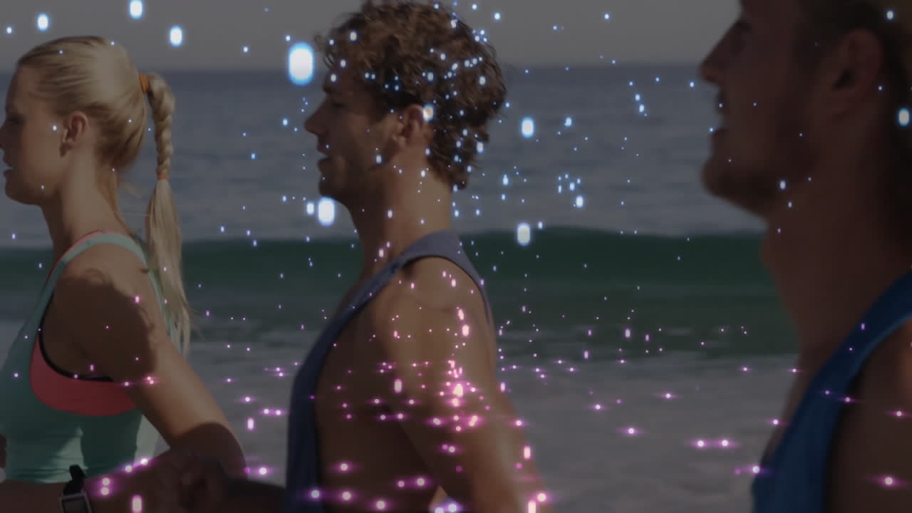 People standing on beach with sparkling light animation over them