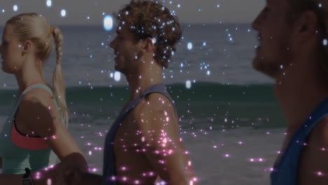 people standing on beach with sparkling light animation over them