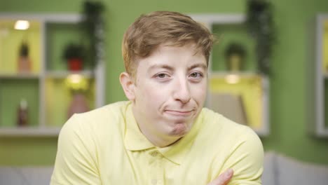 close-up of nerdy and shy young man looking at camera.