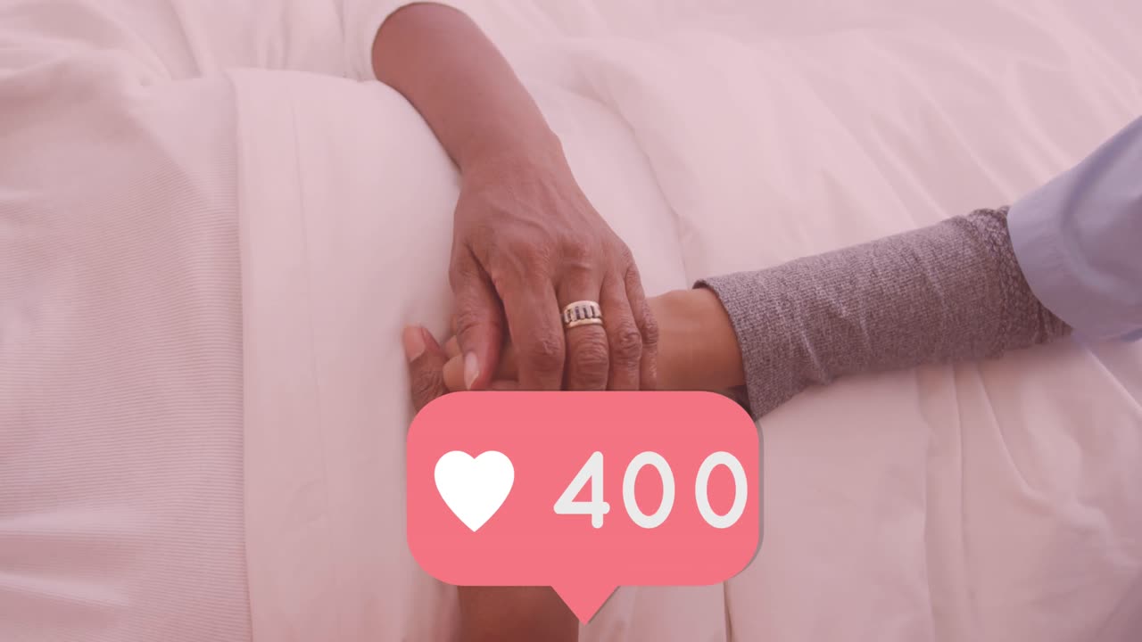 Animation of speech bubble with heart icon and numbers over female doctor holding patient's hand