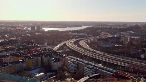 aerial tracking video of highway in stockholm during sunset