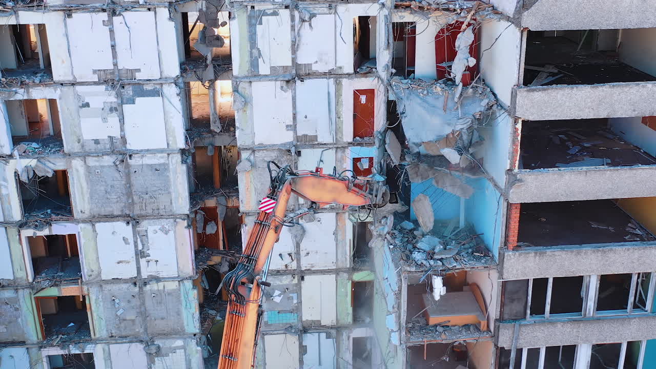 Excavator demolition constructions. Aerial view of destruction by machine.