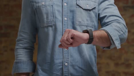 man checking smartwatch