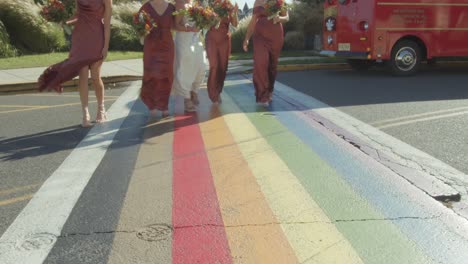 bride and bridesmaids crossing a street on a