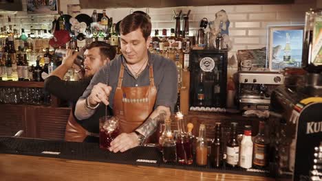 bartenders making cocktails at a bar