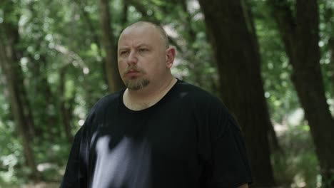 a man walking through forest trees