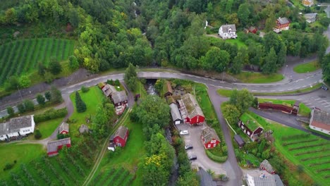 aerial tilt up of farm to mountainsides in ullensvang village in norway