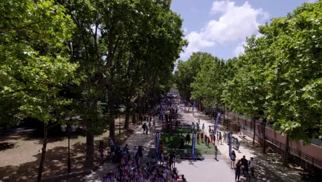 slow aerial dolly of people playing sports in preparation for the olympic games in montpellier