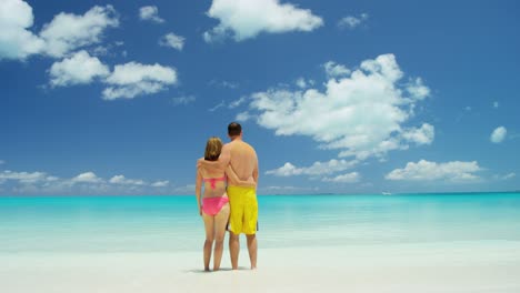 caucasian couple in swimwear on luxury beach vacation