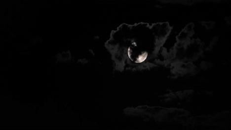 full moon inside clouds during night